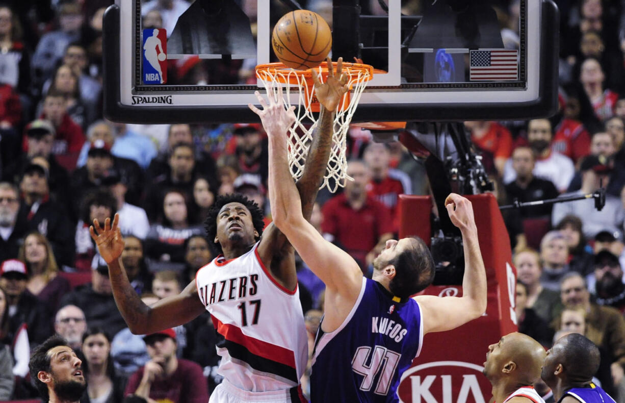 Portland Trail Blazers center Ed Davis (17) and Sacramento Kings center Kosta Koufos (41) go after a rebound during the first half of an NBA basketball game in Portland, Ore., Tuesday, Jan. 26, 2016.