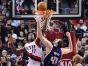 Portland Trail Blazers center Ed Davis (17) and Sacramento Kings center Kosta Koufos (41) go after a rebound during the first half of an NBA basketball game in Portland, Ore., Tuesday, Jan. 26, 2016.