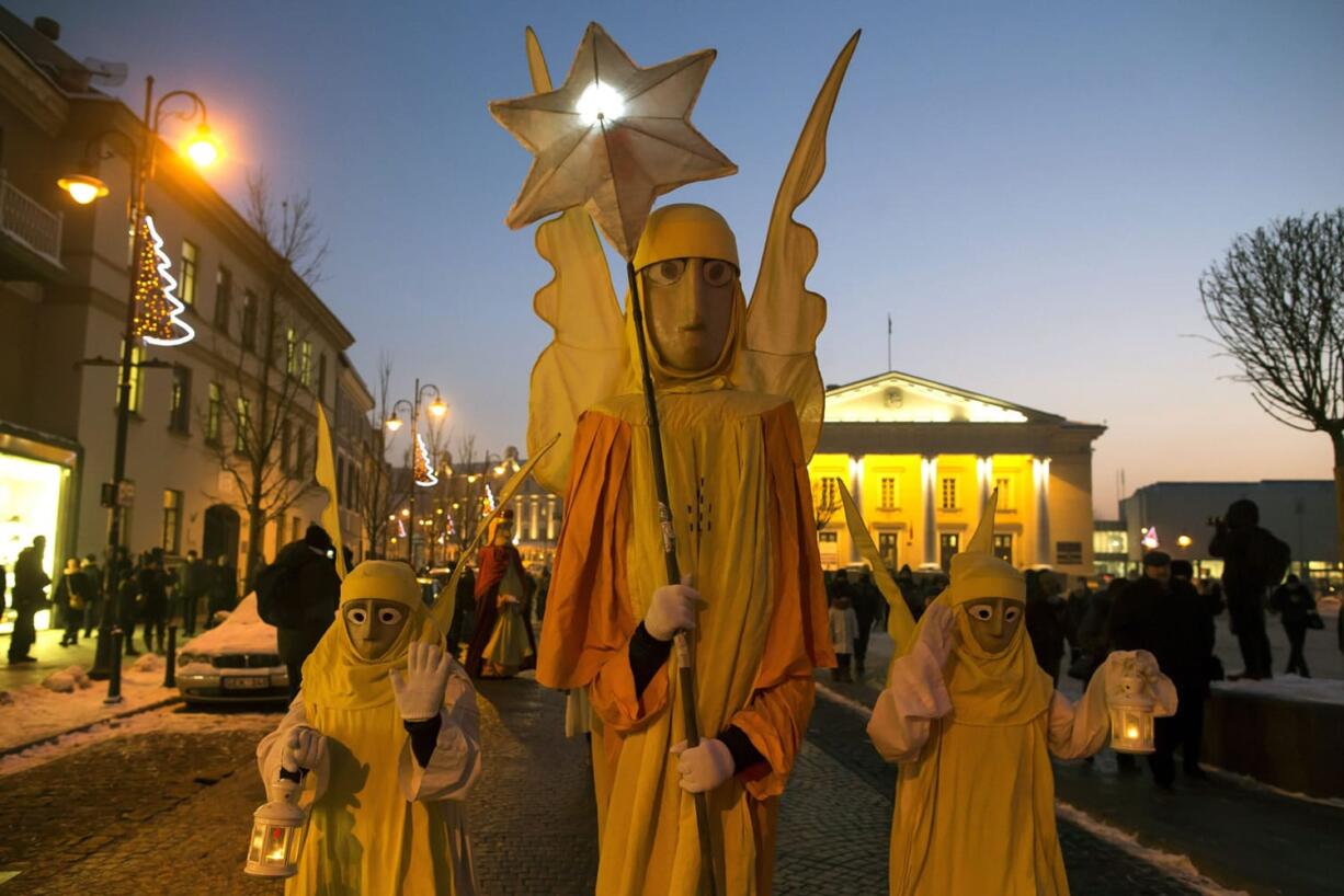 People parade through the streets as part of celebrations of Three Kings Day in downtown Vilnius, Lithuania, on Wednesday. Epiphany, the 12th night of Christmas, marks the day the three wise men visited Christ.