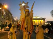 People parade through the streets as part of celebrations of Three Kings Day in downtown Vilnius, Lithuania, on Wednesday. Epiphany, the 12th night of Christmas, marks the day the three wise men visited Christ.