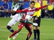 FC Dallas' Carlos Rodriguez, right, fights for the ball with Portland Timbers' Chris Taylor during an MLS.