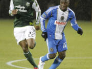 don ryan/The Associated Press
Portland Timbers defender Rodney Wallace, left, pressures Philadelphia Union forward Freddy Adu on Monday.