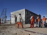 Inmates work on the construction of a chapel inside the state prison in Ciudad Juarez on Sunday,. On Feb. 17, Pope Francis will visit the prison and the chapel.