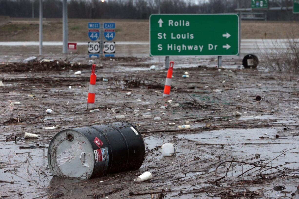 A barrel from an auto store sits amid flood debris Dec. 30 in Fenton, Mo. (ROBERT COHEN/St.