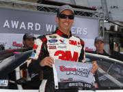 Greg Biffle poses for photos after the pole position during qualifying for Sunday's NASCAR Sprint Cup Series auto race on Friday, March 16, 2012, in Bristol, Tenn.