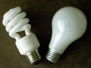 A traditional incandescent bulb, right, and a more energy-efficient compact fluorescent.