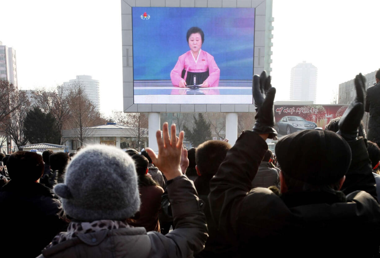 North Koreans watch a news broadcast on a video screen outside Pyongyang Railway Station in Pyongyang, North Korea, on Wednesday.