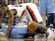 Portland Trail Blazers' Marcus Camby (23) and Denver Nuggets' Ty Lawson, watch a loose ballin the second half during an NBA basketball game Saturday, Feb. 4, 2012, in Portland, Ore. The Trail Blazers defeated the Nuggets 117-97.