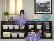 Professional organizer Rachel Strisik's 4-year-old twins Marin, left, and Ellie play dress-up in their playroom of their Bethesda, Md., home.