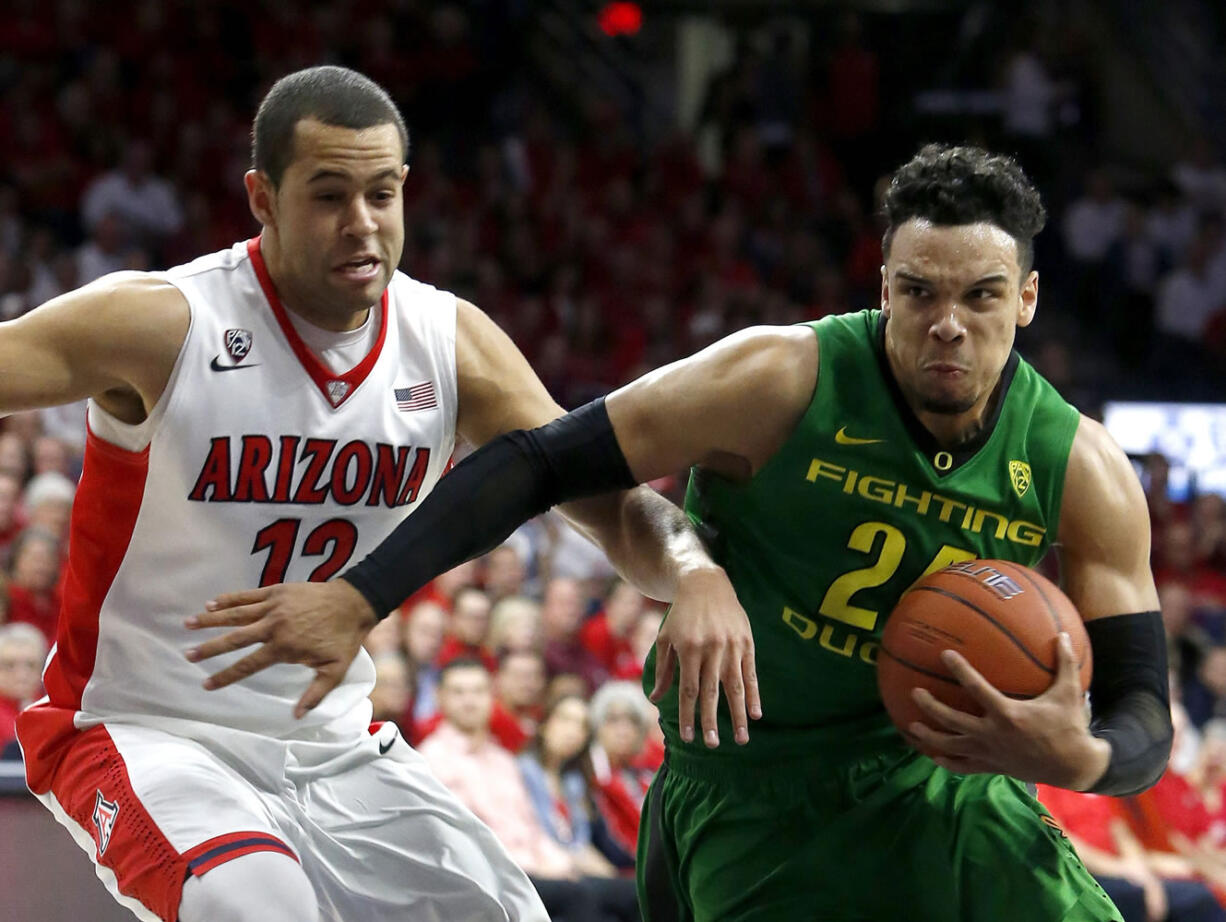 Oregon forward Dillon Brooks (24) drives past Arizona forward Ryan Anderson during the first half of an NCAA college basketball game, Thursday, Jan. 28, 2016, in Tucson, Ariz.