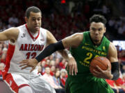 Oregon forward Dillon Brooks (24) drives past Arizona forward Ryan Anderson during the first half of an NCAA college basketball game, Thursday, Jan. 28, 2016, in Tucson, Ariz.