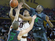 Arizona State Sun Devils guard Tra Holder (0) shoots between Oregon Ducks guard Casey Benson (2) and forward Chris Boucher (25) during the second half of their NCAA basketball game Sunday, Jan. 31, 2016 in Tempe, Ariz.