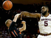 Arizona State's Obinna Oleka (5) knocks the ball away from Oregon State's Olaf Schaftenaar during the first half of an NCAA college basketball game, Thursday, Jan. 28, 2016, in Tempe, Ariz.