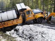 An Oregon Department of Transportation snow plow got stuck in a ditch on U.S. Highway 101 in Coos County, Ore., on Tuesday.