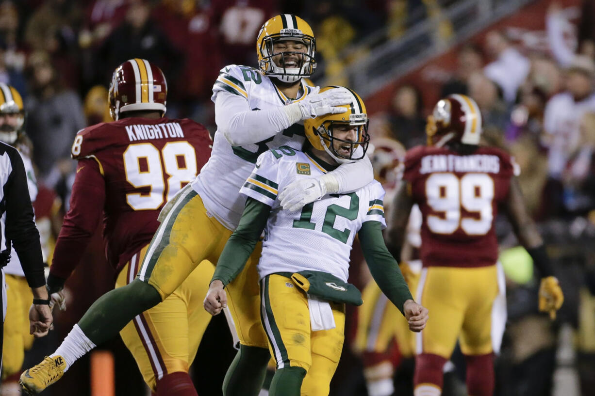 Green Bay Packers tight end Richard Rodgers (82) celebrates with quarterback Aaron Rodgers (12) after wide receiver Davante Adams caught a touchdown pass during the first half of an NFL wild-card playoff football game against the Washington Redskins in Landover, Md., Sunday, Jan. 10, 2016.