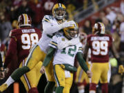 Green Bay Packers tight end Richard Rodgers (82) celebrates with quarterback Aaron Rodgers (12) after wide receiver Davante Adams caught a touchdown pass during the first half of an NFL wild-card playoff football game against the Washington Redskins in Landover, Md., Sunday, Jan. 10, 2016.