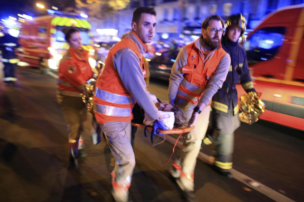 A woman is evacuated from Paris&#039; Bataclan concert hall in November after gunmen attacked the venue. Video released Sunday by the Islamic State shows the extremists who carried out the Nov. 13 attacks in Paris committing previous atrocities.