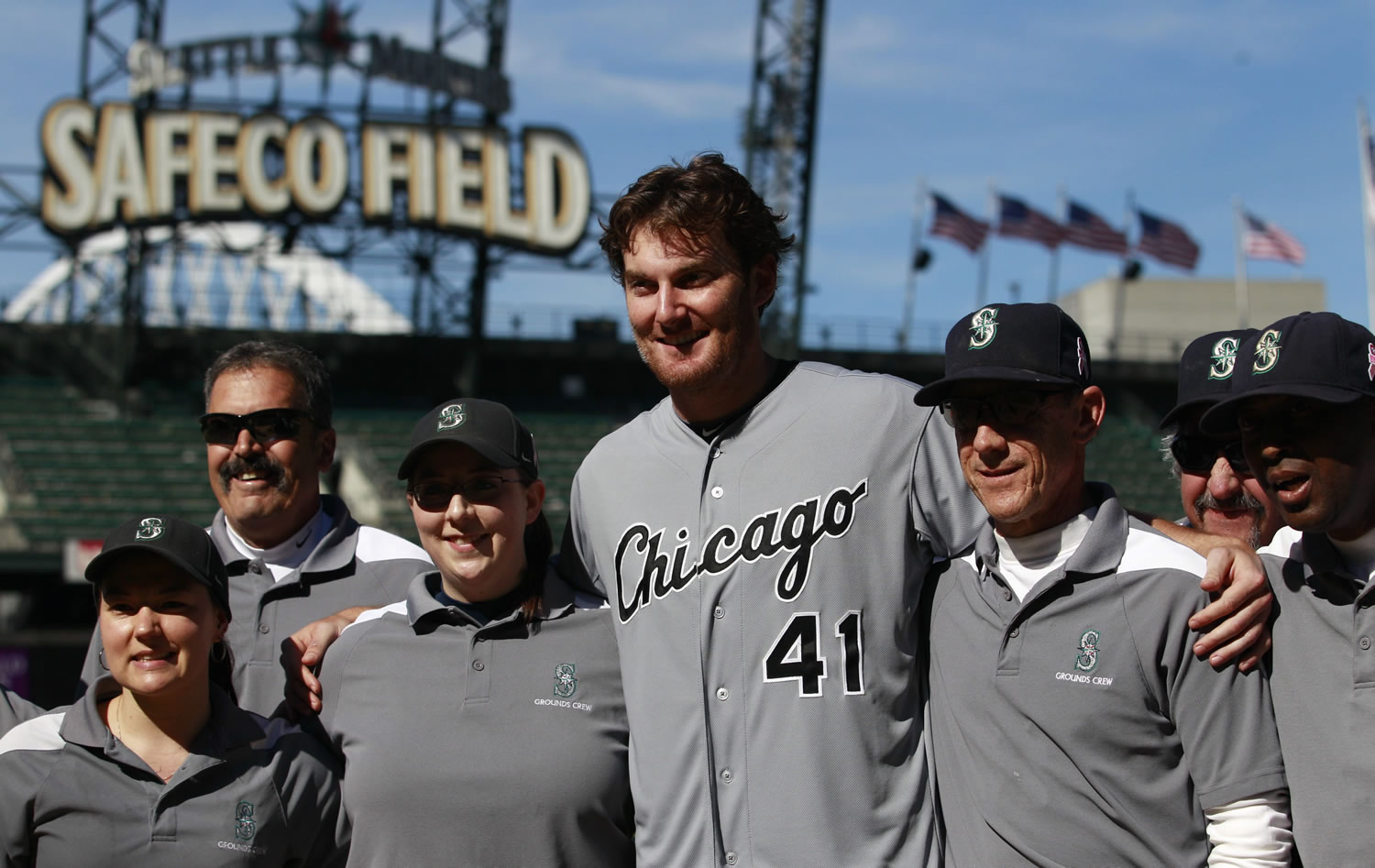 Chicago White Sox starting pitcher Phil Humber, center, poses with members of the Safteco Field grounds crew.