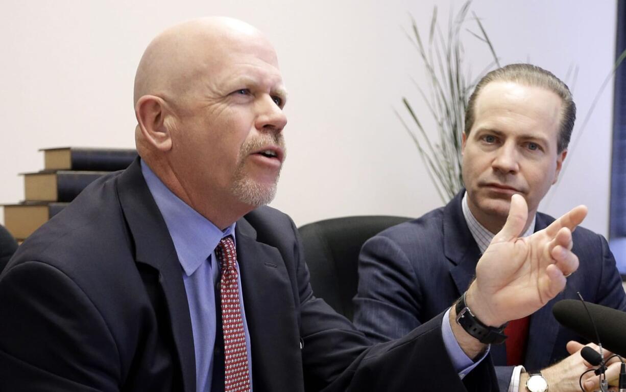 Attorney Terry Yates, left, answers a question as fellow attorney Jared Woodfill listens during a news conference Wednesday, Jan. 27, 2016, in Houston. Both attorneys represent David Daleiden and Sandra Merritt who are accused of using fake driver&#039;s licenses to infiltrate the nation&#039;s largest abortion provider in order to make videos that accused Planned Parenthood of illegally selling fetal tissue to researchers for profit. (AP Photo/David J.