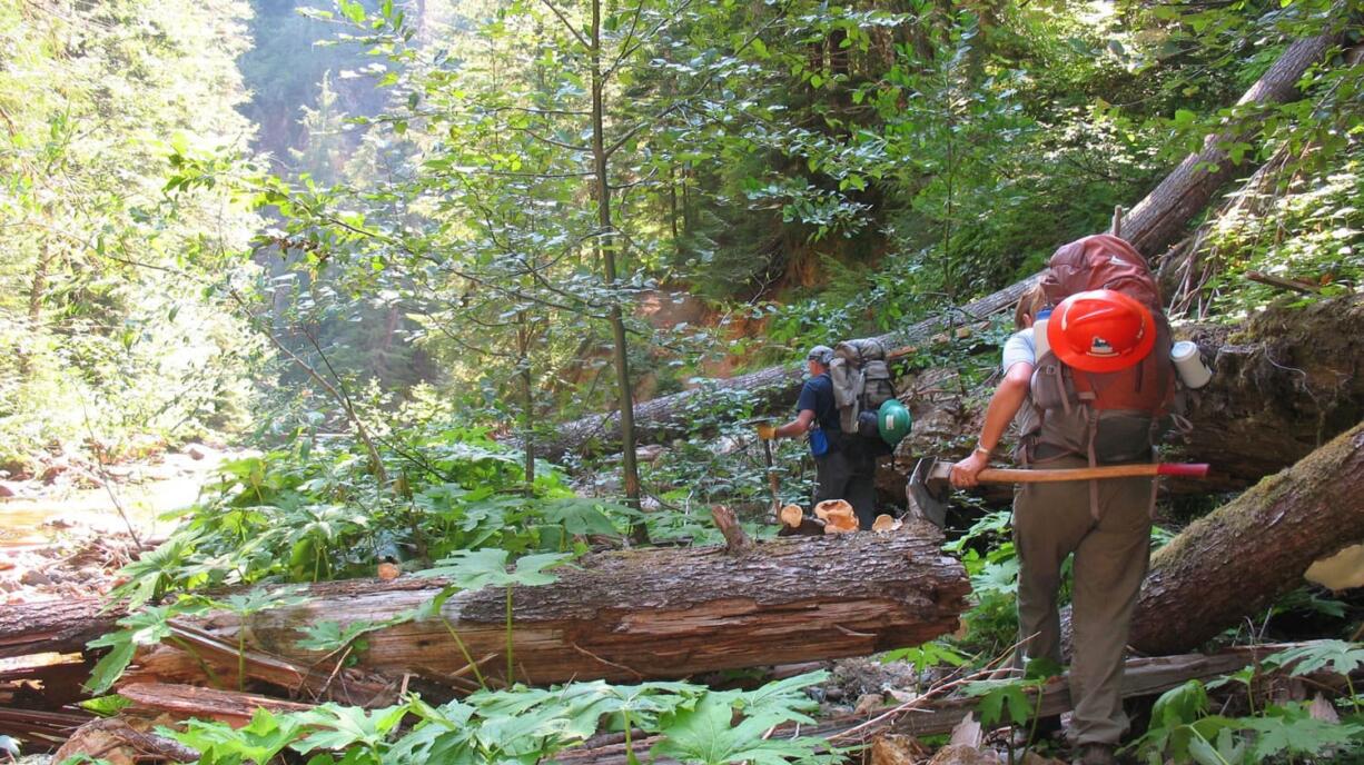 Volunteers Greg Walter and J.B. Robinson cross Straight Creek in the upper North Fork of the Lewis River drainage. Quartz Creek trail No.