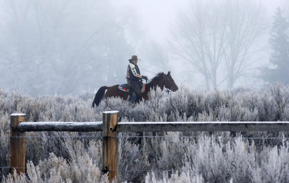 Cowboy Dwane Ehmer, of Irrigon Ore., a supporter of the group occupying the Malheur National Wildlife Refuge, rides his horse Thursday, Jan. 7, 2016, near Burns, Ore. The leader of an American Indian tribe that regards the Oregon nature preserve as sacred issued a rebuke Wednesday to the armed men who are occupying the property, saying they are not welcome at the snowy bird sanctuary and must leave.