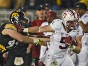 Stanford running back Christian McCaffrey, right, breaks away form Iowa linebacker Josey Jewell during the second half of the Rose Bowl NCAA college football game, Friday, Jan. 1, 2016, in Pasadena, Calif. (AP Photo/Mark J.