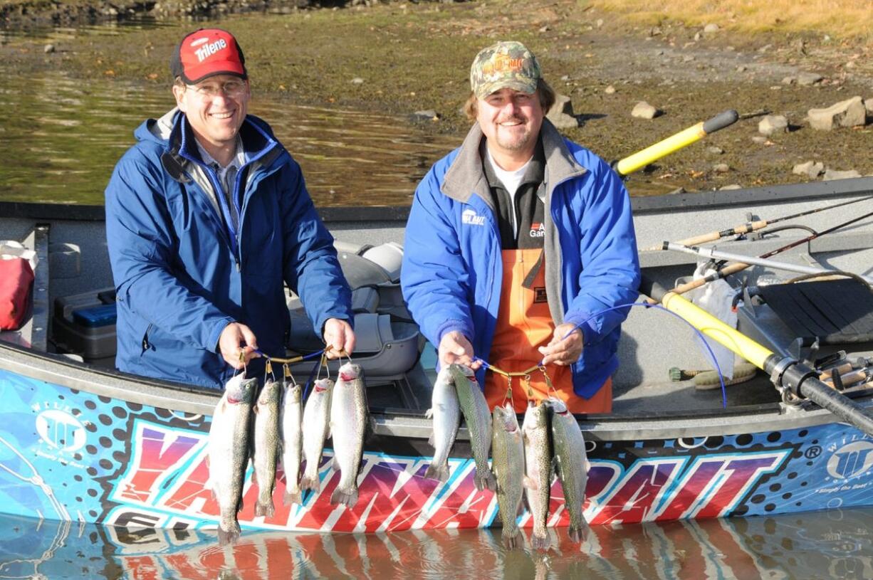 State biologist John Weinheimer, left, and Buzz Ramsey of Yakima Bait show off limits of rainbow trout caught last week at Rowland Lake east of Bingen.