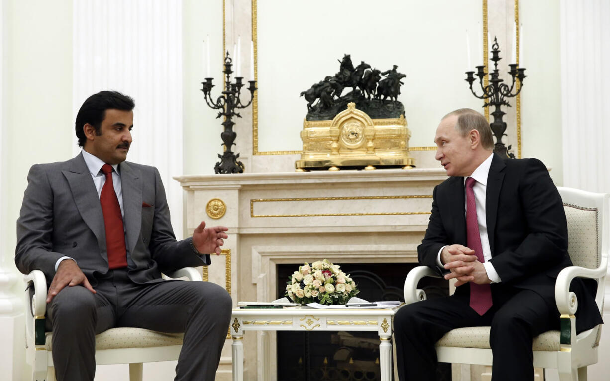 Russian President Vladimir Putin, right, speaks with Qatar&#039;s Emir Tamim bin Hamad Al Thani on Monday at the Kremlin in Moscow.