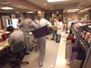 Dr. Marty Bell carries a set of patient X-rays in the emergency room of then-Southwest Washington Medical Center in 2000. Bell is director of emergency services at the now PeaceHealth Southwest Medical Center.