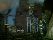 Firefighters enter a house at 26908 N.E. 45th Avenue east of Ridgefield on Tuesday night.