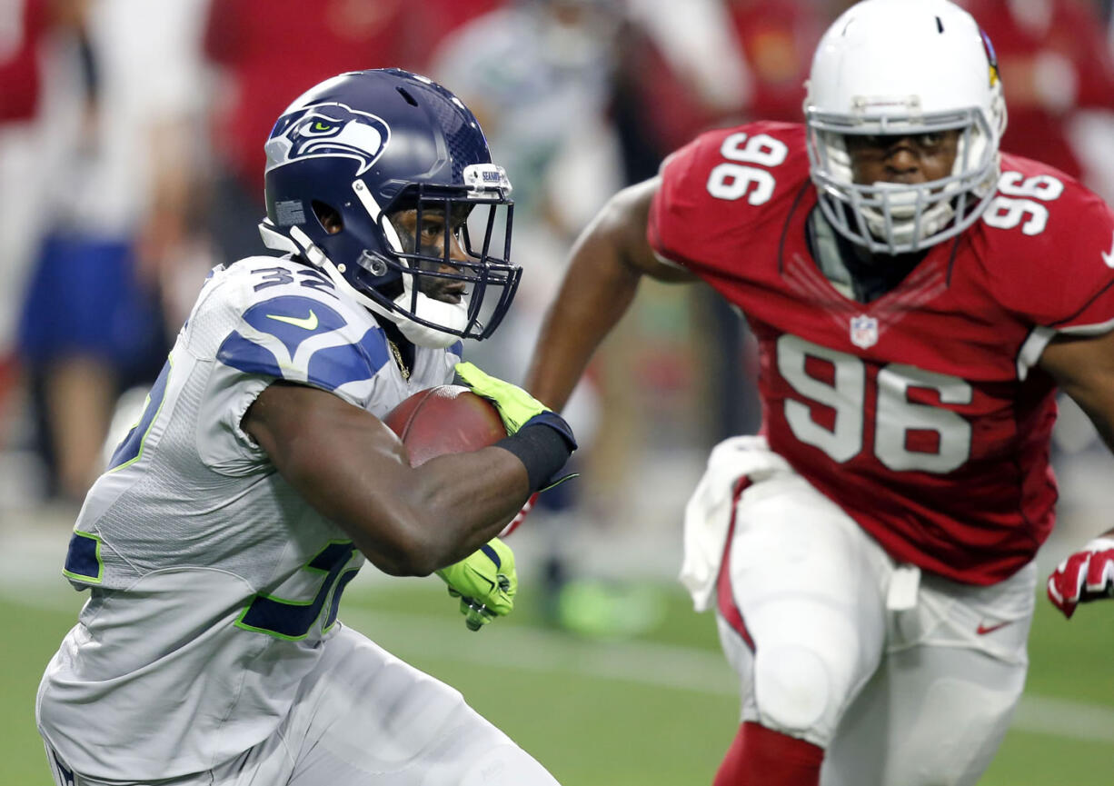 Seattle Seahawks running back Christine Michael (32) runs as Arizona Cardinals linebacker Kareem Martin (96) pursues during the first half of an NFL football game, Sunday, Jan. 3, 2016, in Glendale, Ariz. (AP Photo/Ross D.