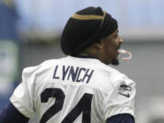 Seattle Seahawks running back Marshawn Lynch holds a candy cane in his mouth as he warms up before NFL football practice, Wednesday, Jan. 6, 2016, in Renton, Wash. Lynch has been recovering since having abdominal surgery last November. (AP Photo/Ted S.