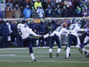 Seattle Seahawks punter Jon Ryan (9) punts during the first half of an NFL wild-card football game against the Minnesota Vikings, Sunday, Jan. 10, 2016, in Minneapolis.