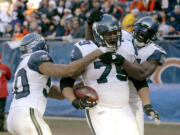 Seattle Seahawks defensive end Red Bryant (79) celebrates with teammates after scoring on an interception return in the second half Sunday.