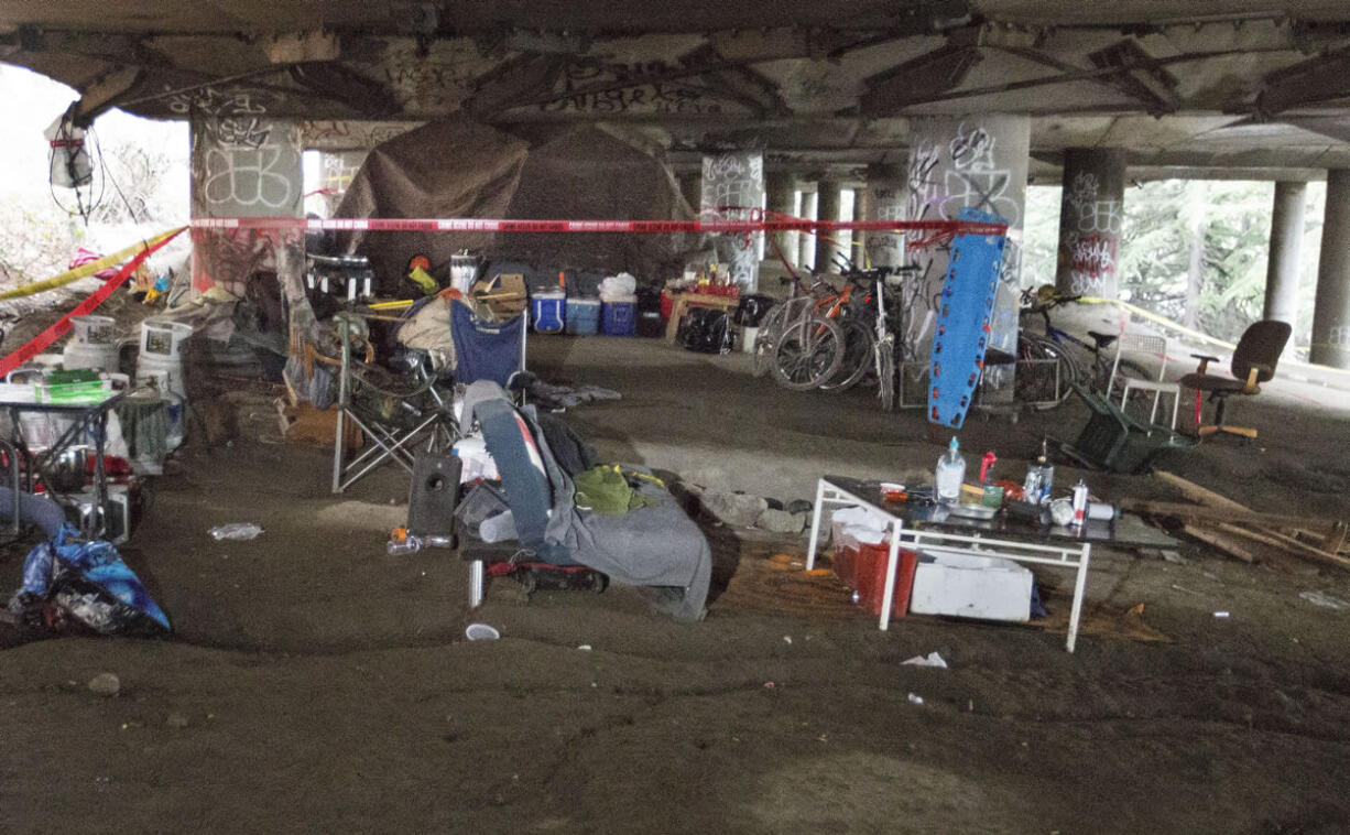 Crime scene tape blocks off an area Wednesday, Jan. 27, 2016, in Seattle, where a fatal shooting occured the night before at a homeless encampment.