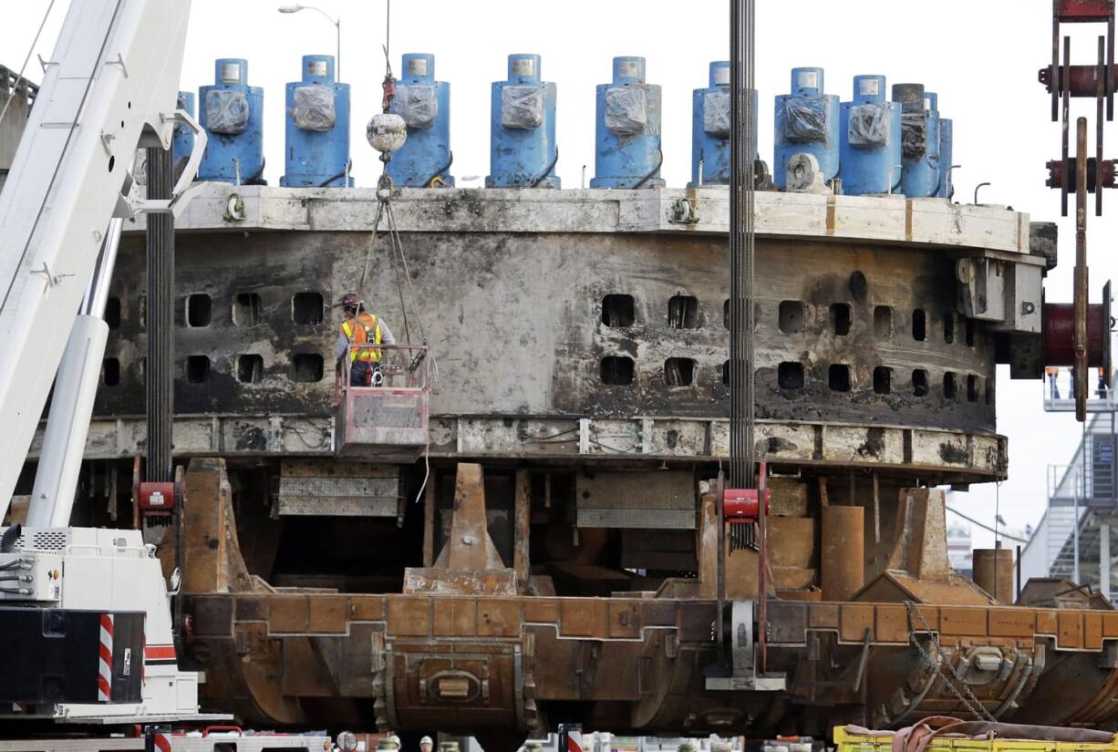 Seattle's tunnel-boring machine has moved past the concrete walls that make up a repair pit and has started digging into soil about 80 feet below street-level along the city's waterfront. After being out of commission for about two years, the machine has tunneled about 73 feet and installed 12 concrete tunnel rings since it started moving again on Dec. 22.