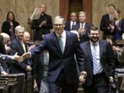 Gov. Jay Inslee shakes hands with legislators after giving his annual State of the State address Tuesday in Olympia. The address came on Day 2 of the 60-day session.