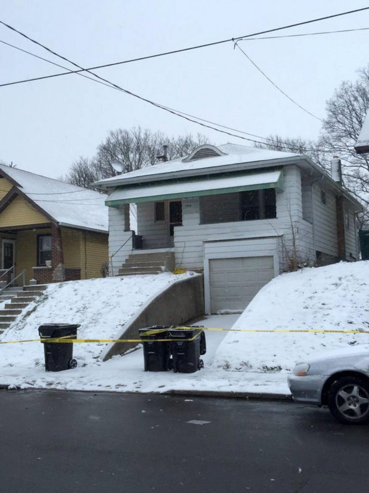 Police tape cordons off a home Tuesday in Cincinnati, where police say a father, who believed he was confronting an intruder in his home, fatally shot his 14-year-old son. The man said he thought the boy  was on his way to school.