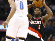 Oklahoma City Thunder guard Russell Westbrook (0) blocks a shot by the Portland Trail Blazers' Raymond Felton (5) during the first half the Thunder's win over Portland, who ended a seven-game road trip.