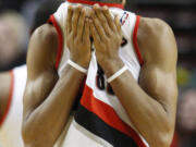 Portland Trail Blazers' Nicolas Batum wipes his face in the second half during an NBA basketball game with the Oklahoma City Thunder Tuesday, March 27, 2012, in Portland, Ore. The Thunder defeated the Trail Blazers 109-95.