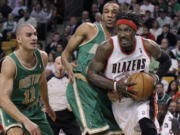 Portland Trail Blazers forward Gerald Wallace drives by Boston Celtics guard Avery Bradley and forward Sasha Pavlovic (11) during the first half Friday.