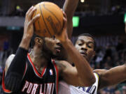 Portland Trail Blazers forward LaMarcus Aldridge drives past Utah Jazz forward Derrick Favors during the first half of Wednesday's preseason game at Salt Lake City.