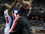 Portland Trail Blazers' Wesley Matthews, right, goes to the basket against Detroit Pistons' Jason Maxiell in the first half Saturday.