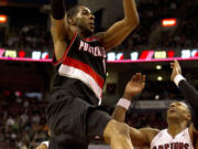 Portland Trail Blazers forward LaMarcus Aldridge drives to the hoop past Toronto Raptors forward James Johnson during second half Friday.