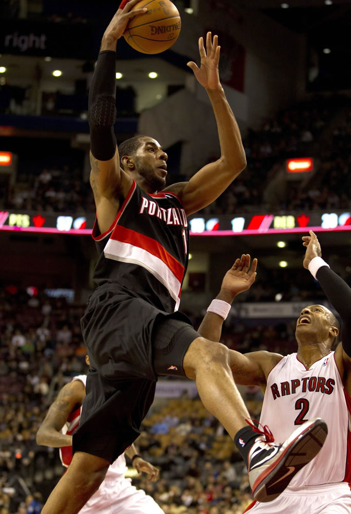 Portland Trail Blazers forward LaMarcus Aldridge drives to the hoop past Toronto Raptors forward James Johnson during second half Friday.