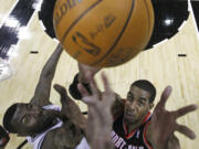 Portland Trail Blazers' LaMarcus Aldridge, right, and San Antonio Spurs' DeJuan Blair, left, reach for a rebound during the first quarter Friday.