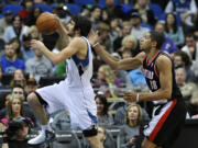 Minnesota Timberwolves' Ricky Rubio, left, of Spain, lays up ahead of Portland Trail Blazers' Nicolas Batum, of France, during the second half of an NBA basketball game Wednesday, March 7, 2012 in Minneapolis. The Timberwolves won 106-94.