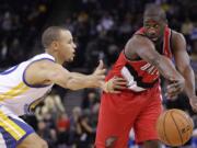 Portland Trail Blazers' Raymond Felton, right, passes away from Golden State Warriors' Stephen Curry during the first half of an NBA basketball game Wednesday, Jan. 25, 2012, in Oakland, Calif.