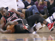 Golden State Warriors' Nate Robinson (2) battles for a loose ball with Portland Trail Blazers Raymond Felton (5) during the second half of an NBA basketball game in Oakland, Calif., Wednesday, Feb. 15, 2012.