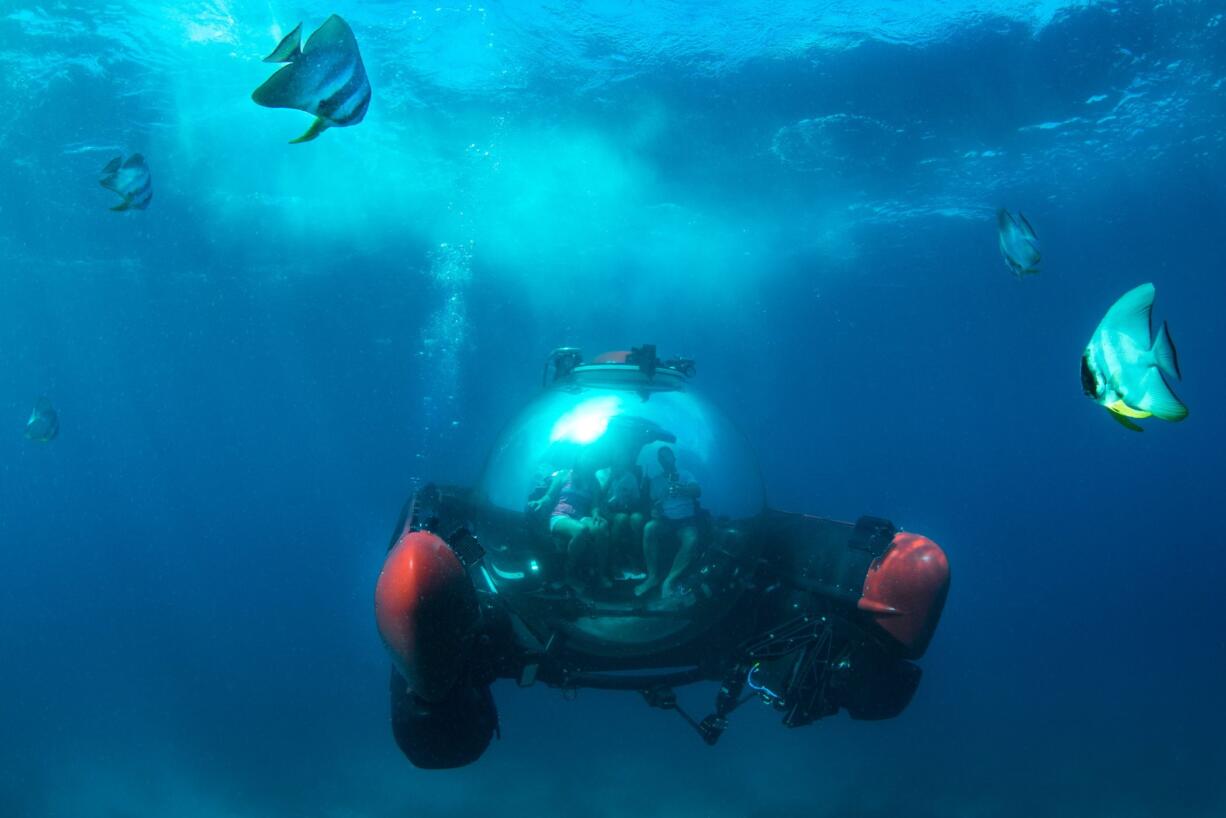 A group of people explore waters off the Seychelles islands in a submersible sightseeing capsule in December, an excursion offered to passengers aboard the Crystal Cruises yacht Crystal Esprit. The glass pod carries two people plus a captain, and the 30-minute ride is $599 a person.